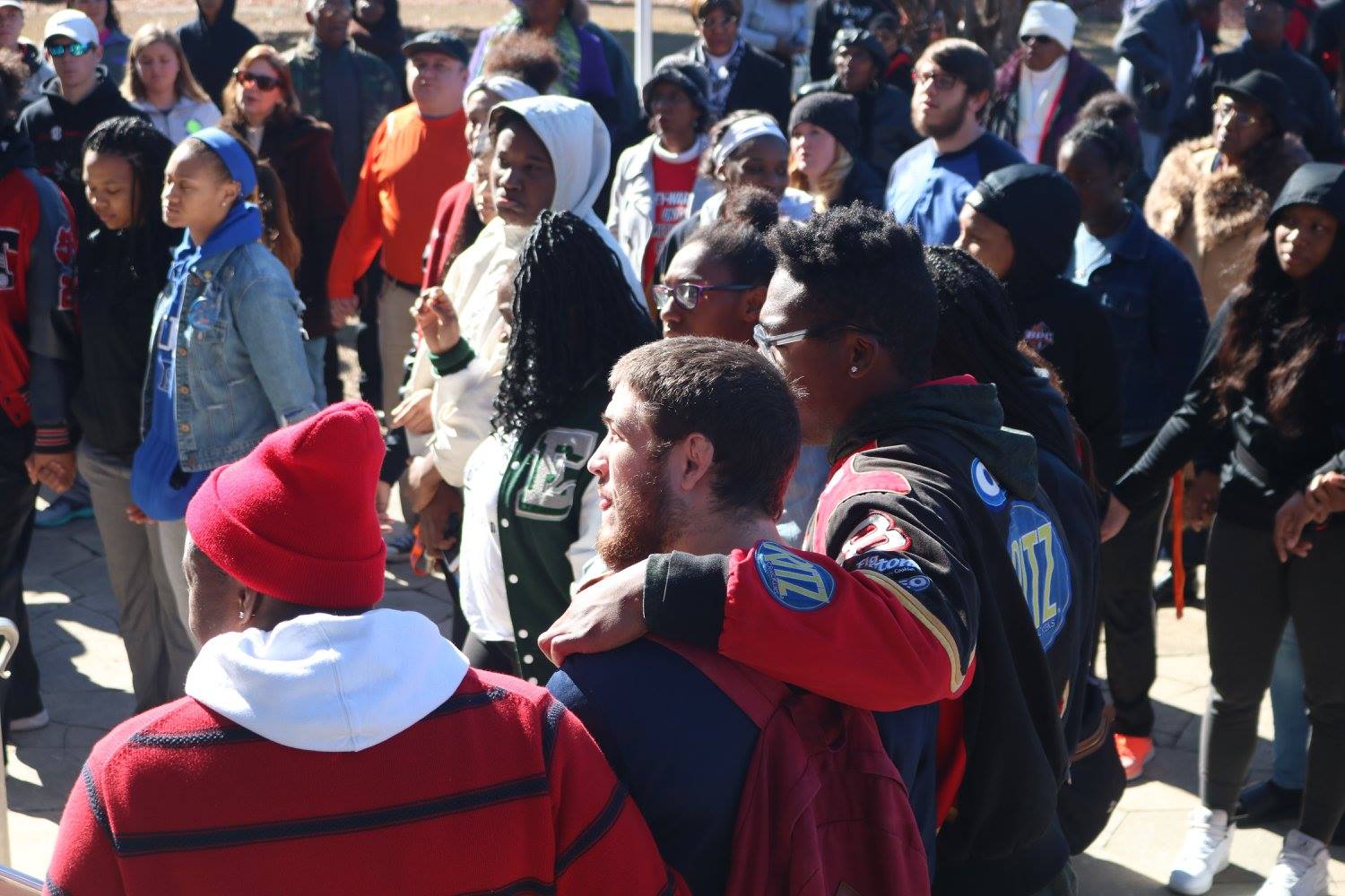 Students link arms while at the Jan. 15 unity service at Montgomery County Courthouse. Photo cred: Jose Carrillo-Garcia.