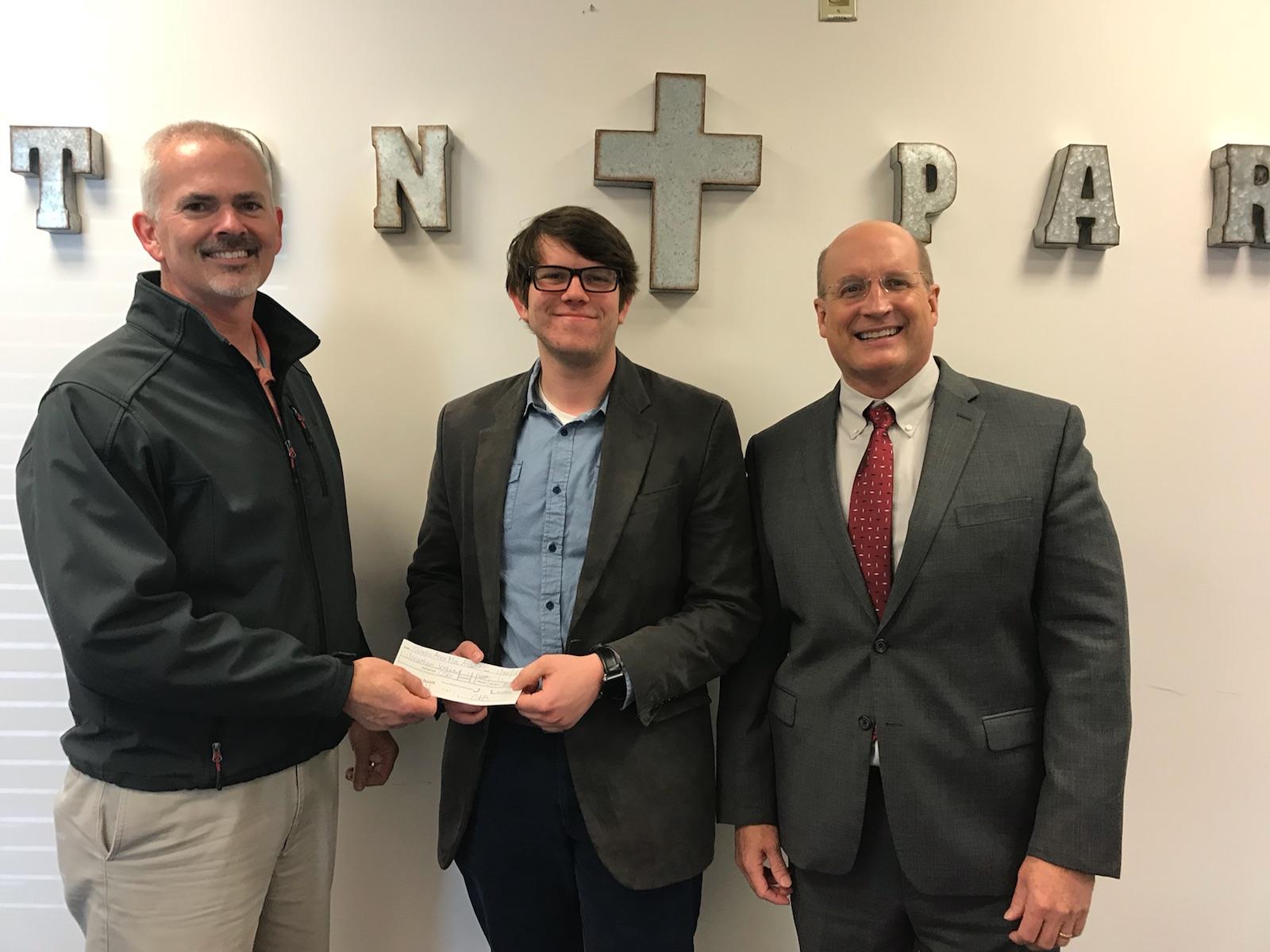 From left, Clint Hutcheson, Director of Mercy Ministries, presents a $1000 ministerial scholarship to Jonathan Jenkins, a Brewton-Parker Christian Studies student while Dr. Steve Echols, president of Brewton-Parker, stands nearby. (Photo credit: Laura Hay)